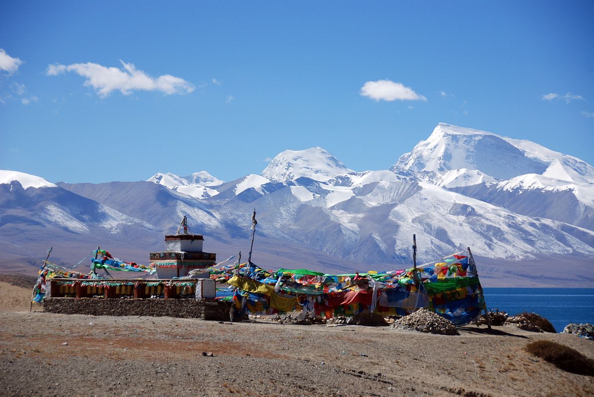 17 Seralung Gompa Chorten And Prayer Wheels With Lake Manasarovar And Gurla Mandhata Seralung Gompa chorten next to Lake Manasarovar with a row of prayer wheels and Gurla Mandhata.